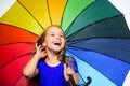 Small girl with umbrella in rainy weather. Happy little girl with umbrella. Autumn fashion. Child. Happy childhood