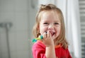 Small girl washing her teeth