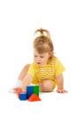 Small girl in yellow build toy pyramid Royalty Free Stock Photo