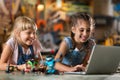 Girls cooperating while making a robot