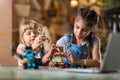 Young girls building toy construction machine