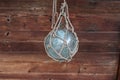 Small glass ball braided with a rope that is used as a float on fishing nets Royalty Free Stock Photo