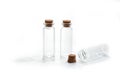 Small glass bottles with cork lid on white background