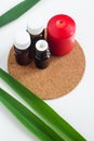 Small glass bottles with essential oil and red candle. Aromatherapy, spa and herbal medicine ingredients. Top view Royalty Free Stock Photo