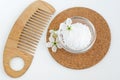 Small glass bowl with epsom bath salts foot soak and wooden hair brush. Natural spa, beauty treatment, zero waste concept. Royalty Free Stock Photo