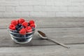 Small glass bowl full of blueberries with raspberries on top, wi Royalty Free Stock Photo