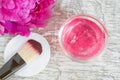 Small glass bowl with pink gel mask with flowers extract. Top view, copy space. Royalty Free Stock Photo