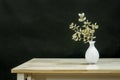 A small glass centerpiece with some dried oak branches