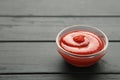 Small glass condiment bowl of red tomato sauce ketchup on black background Royalty Free Stock Photo