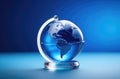 small glass globe, planet earth figurine, environmental protection, blue background Royalty Free Stock Photo