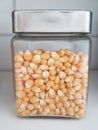 Small glass jar with metal lid with popcorn Royalty Free Stock Photo