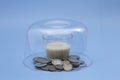 small glass of milk with coins around