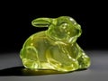 small glass rabbit figurine, chartreuse, dark background, slight shadow Royalty Free Stock Photo