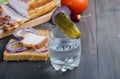 Small glass with Russian vodka,sandwich with Smoked bacon and