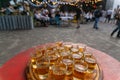 Small glasses filled with brandy on a wooden tray Royalty Free Stock Photo