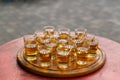 Small glasses filled with brandy on a wooden tray Royalty Free Stock Photo