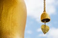 Small gold color of buddhist bell in the temple and blue sky ,Thailand. Royalty Free Stock Photo