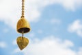 Small gold color of buddhist bell in the temple and blue sky ,Thailand. Royalty Free Stock Photo