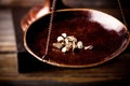Small gold nuggets in an antique measuring scale Royalty Free Stock Photo