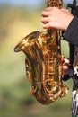 Small gold saxophone in hands Royalty Free Stock Photo