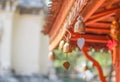 Small golden bells hanging under roof Royalty Free Stock Photo