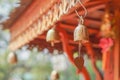 Small golden bells hanging under roof Royalty Free Stock Photo