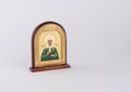 Small golden orthodox icon on a wooden stand