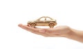 Small golden toy car on the palm of your hand on a black background. Concept of car insurance, guarantee and protection Royalty Free Stock Photo