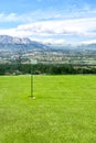 Small golf course amidst beautiful scenery with mountains