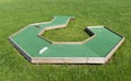 Small golf course built for children in a recreational space.