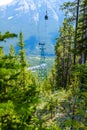 Small gondola hovering over tree tops Royalty Free Stock Photo