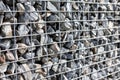 Small granite stones behind a metal mesh, design fence, garden concept Royalty Free Stock Photo