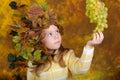 Small grape fairy with grapes in hands Royalty Free Stock Photo