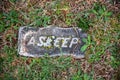 Small grave stone in green grass reads ASLEEP Royalty Free Stock Photo