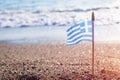 Small Greek waving flag flying over sea water Royalty Free Stock Photo