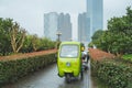 Small green car are in the park. The back has a city view Royalty Free Stock Photo