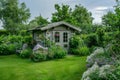 Small green fenced back yard with garden and shed. Gardening tools shed. Generative AI Royalty Free Stock Photo