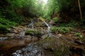 Small green forest waterfall in the cave mountains, cascades on a mountain river. The concept of active holidays, holidays Royalty Free Stock Photo