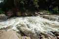 Small green forest waterfall in the cave mountains, cascades on a mountain river. The concept of active holidays, holidays Royalty Free Stock Photo