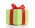 Small green gift box with red ribbon bow isolated on white Royalty Free Stock Photo
