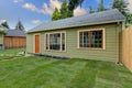 Small green guest house in the fenced backyard. Royalty Free Stock Photo