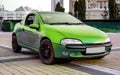 Small green old sportcar against city landscape Royalty Free Stock Photo