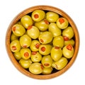 Pickled small green olives, filled with red sweet pepper in a wooden bowl Royalty Free Stock Photo