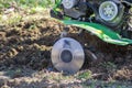 Small green plowing machine in hands of a farmer, tillage equipment, agricultural machine, agriculture, making arable in soil