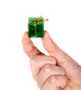 Small green present in man's hand