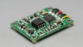 A small green printed circuit board with various electronic components such as microchips capacitors and resistors mounted on its Royalty Free Stock Photo