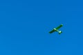 Small green private plan on bright blue summer sky for aerial views and tourist attractions