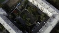 Small green summer courtyard surrounded by square shaped residential houses. Stock footage. Top aerial view of Royalty Free Stock Photo