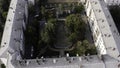 Small green summer courtyard surrounded by square shaped residential houses. Stock footage. Top aerial view of Royalty Free Stock Photo