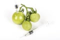 Small green tomatoes grape With syringe. Concept non organic food, genetically modified organism